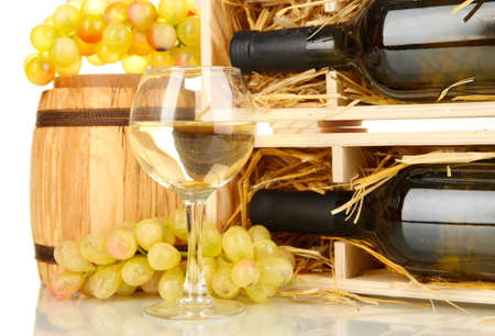 Wooden case with wine bottle, barrel, wineglass and grape isolated on whiteの写真素材