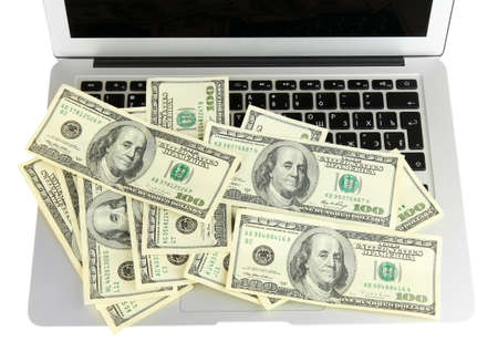 Money on laptop isolated on whiteの写真素材