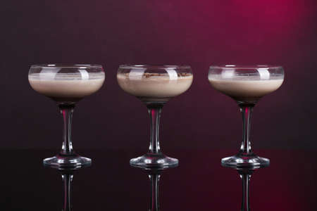 Cream cocktails on dark purple backgroundの写真素材
