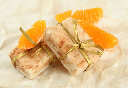 Natural handmade soap and orange, on beige backgroundの写真素材
