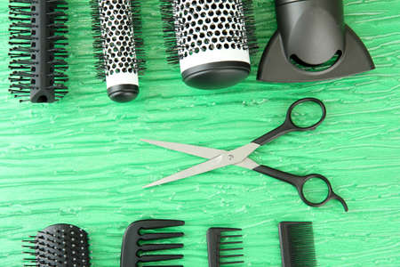 Comb brushes, hairdryer and cutting shears,on color backgroundの写真素材