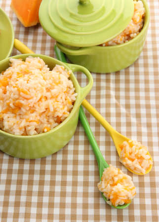 Taste rice porridge with pumpkin in saucepans on tablecloth background
の写真素材