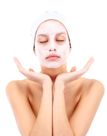 Young woman with clay facial mask, isolated on whiteの写真素材