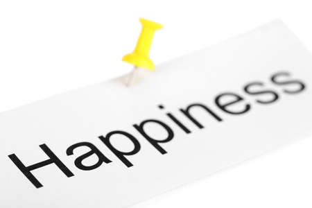 Push pin on paper with word happiness written on it isolated on whiteの写真素材