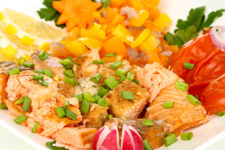 Appetizing sliced salmon with lemon and vegetables close upの写真素材