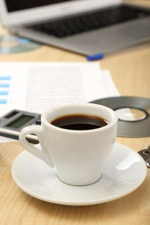 Cup of coffee on office desktop close-upの写真素材