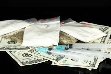 Drugs, money and  syringes, isolated on blackの写真素材