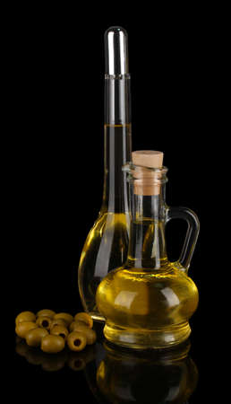 Different types of oil with olives on dark backgroundの写真素材