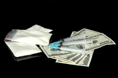 Drugs, money and syringes, isolated on blackの写真素材