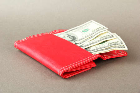 Purse with hundred dollar banknotes, on color backgroundの写真素材