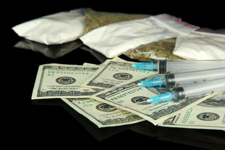 Drugs, money and  syringes, isolated on blackの写真素材