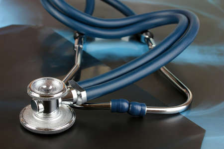 Medical stethoscope on an x-ray picture close upの写真素材