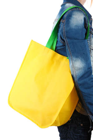 Yellow bag with green handles on shoulder isolated on whitの写真素材