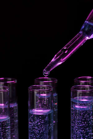 test-tubes with liquid on black backgroundの写真素材