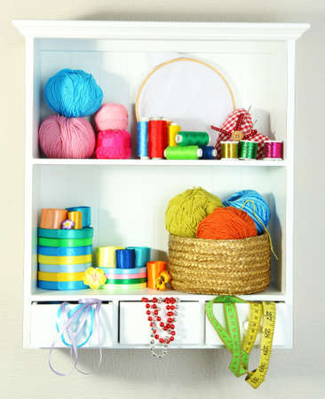 Beautiful white shelves with thread and material for handicraftsの写真素材
