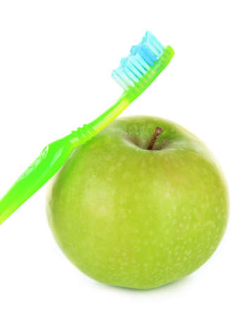Apple with a toothbrush isolated on whiteの写真素材