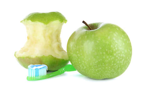 Apples with a toothbrush isolated on whiteの写真素材