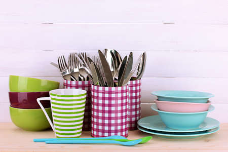 Cups, bowls nd other utensils in metal containers isolated on light backgroundの写真素材