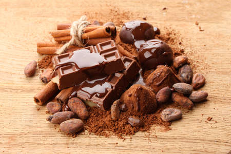 Composition of chocolate sweets, cocoa and  spices on wooden backgroundの写真素材