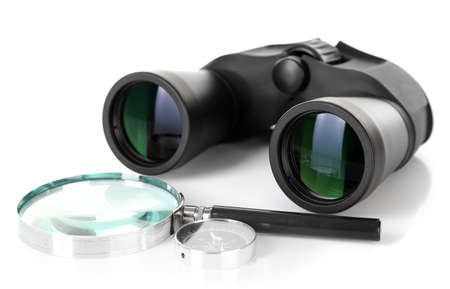 Black modern binoculars with magnifying glass and compass isolated on whiteの写真素材