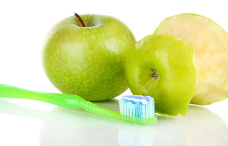 Apples with a toothbrush isolated on whiteの写真素材