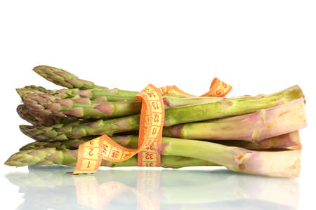 delicious asparagus and measuring tape isolated on whiteの写真素材