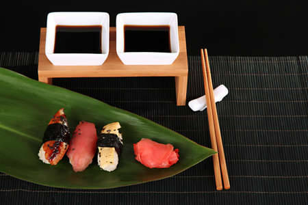 Tasty Maki sushi - Roll on green leaf on gray backgroundの写真素材