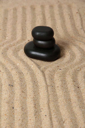 Zen garden with raked sand and round stones close upの写真素材