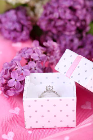Beautiful box with wedding ring on purple backgroundの写真素材