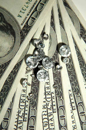 Beautiful shining crystals (diamonds) on money backgroundの写真素材