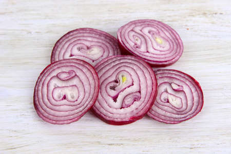 Purple onion on cutting board isolated on whiteの写真素材