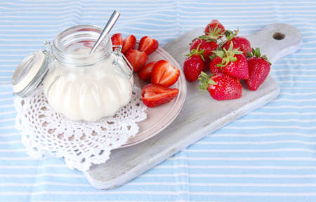 Strawberries on board cutting on striped napkinの写真素材