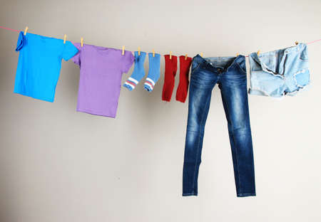Laundry line with clothes on wall backgroundの写真素材
