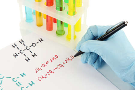 Hand scientist writing formulas isolated on whiteの写真素材