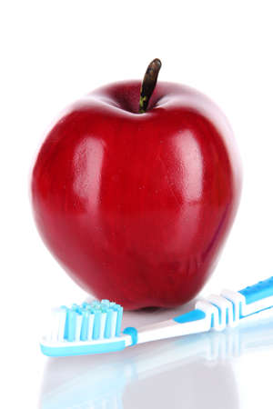 Apple with a toothbrush isolated on whiteの写真素材