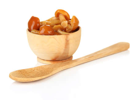 Mushrooms in wooden bowl, isolated on whiteの写真素材