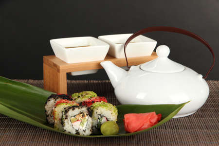 Tasty Maki sushi - Roll on green leaf on table on gray backgroundの写真素材