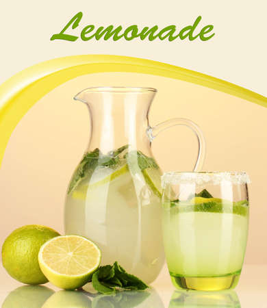 Lemonade in pitcher and glass on yellow backgroundの写真素材