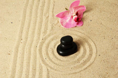 Zen garden with raked sand and round stones close upの写真素材