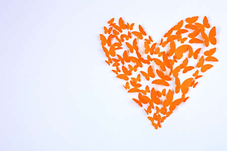 Paper butterflies in form of heart on wallの写真素材