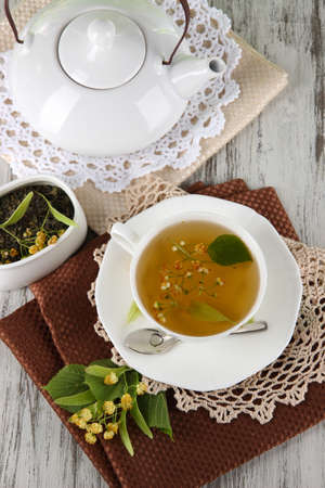 Cup of tea with linden on napkins on    wooden tableの写真素材