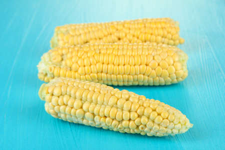 Fresh corn on color wooden backgroundの写真素材