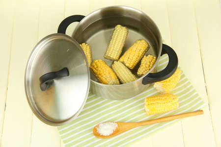 Boiled corn in pan, on wooden  table, on wooden backgroundの写真素材