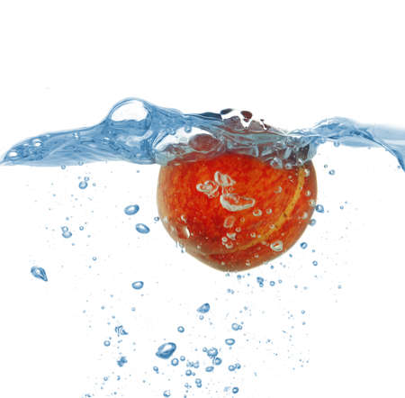 Juicy fruit under water, isolated on whiteの写真素材