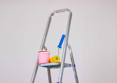 Metal ladder and paint in roomの写真素材
