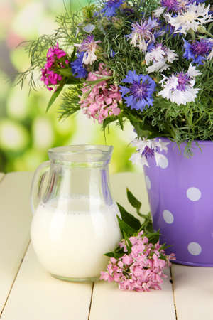 Beautiful bouquet in pail on wooden table on natural backgroundの写真素材