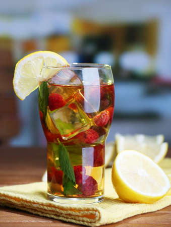 Iced tea with raspberries and mint on wooden table, outdoorsの写真素材
