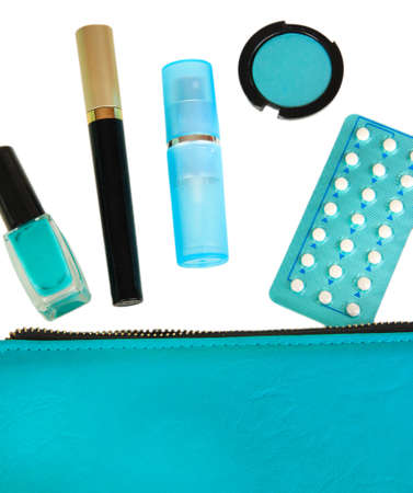 Hormonal pills in women's make-up bag isolated on whiteの写真素材