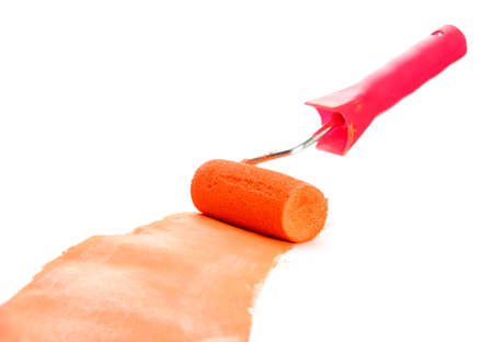 roller with orange paint isolated on whiteの写真素材