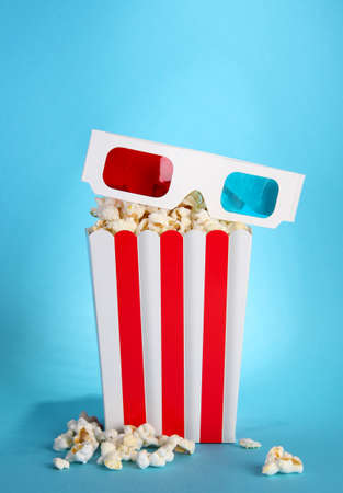Popcorn and 3D glasses on blue backgroundの写真素材
